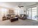 Bright living room featuring comfortable seating, a ceiling fan, and sliding glass door to the exterior at 26071 W Sequoia Dr, Buckeye, AZ 85396