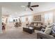 Inviting living room featuring plush seating, neutral tones, and an adjacent dining area at 26071 W Sequoia Dr, Buckeye, AZ 85396