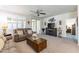 Cozy living room showcasing a fireplace, media center, and sliding glass door to the exterior at 26071 W Sequoia Dr, Buckeye, AZ 85396