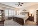 Comfortable main bedroom featuring a large bed, bright windows, and stylish furnishings at 26071 W Sequoia Dr, Buckeye, AZ 85396
