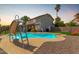 Inviting backyard with pool, slide, diving board and mature trees at 2643 E Menlo St, Mesa, AZ 85213