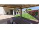 Spacious backyard featuring a covered patio, grill, lush grass, a pool, and an artistic desert-themed mural at 2643 E Menlo St, Mesa, AZ 85213