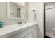 Clean bathroom featuring white cabinets and countertop, a modern mirror, and a shower with coordinating hardware at 2643 E Menlo St, Mesa, AZ 85213