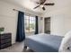 Bright bedroom with a large window, blue curtains, a comfortable bed, and a spacious closet for storage at 2643 E Menlo St, Mesa, AZ 85213