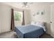 Cozy bedroom features a ceiling fan, window with curtains, and neutral walls providing a relaxing retreat at 2643 E Menlo St, Mesa, AZ 85213