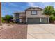 Charming two-story home featuring a well-maintained front yard and a spacious three-car garage at 2643 E Menlo St, Mesa, AZ 85213