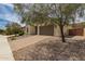 Single-story home with a two-car garage, desert landscaping, and a spacious paved driveway at 26860 N 102Nd Ln, Peoria, AZ 85383