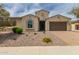 Charming single-story home with a two-car garage, desert landscaping, and a quaint architectural details at 26860 N 102Nd Ln, Peoria, AZ 85383