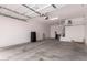 Spacious garage with overhead storage racks and ample room for parking and projects at 26860 N 102Nd Ln, Peoria, AZ 85383