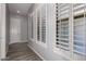 Hallway with wood floors and plantation shutters at 26860 N 102Nd Ln, Peoria, AZ 85383
