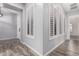 Hallway with gray walls, wood floors and plantation shutters at 26860 N 102Nd Ln, Peoria, AZ 85383
