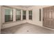 Cozy sunroom featuring natural light from large windows and a door leading to the outside at 26860 N 102Nd Ln, Peoria, AZ 85383