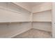 Spacious walk-in closet providing ample storage with shelving and hanging rods at 26860 N 102Nd Ln, Peoria, AZ 85383