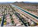 Overhead capture of houses near a blue canal set against a mountain landscape at 29339 N 67Th Ave, Peoria, AZ 85383