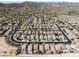 An aerial view showcasing a residential neighborhood with mountain views in the background at 29339 N 67Th Ave, Peoria, AZ 85383
