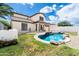 Landscaped backyard features a pool, rock features, grassy area and fenced perimeter at 29339 N 67Th Ave, Peoria, AZ 85383