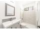 Clean bathroom featuring a modern sink, toilet, and shower with marble tile at 29339 N 67Th Ave, Peoria, AZ 85383