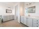 Well-lit primary bathroom with gray shaker cabinets, double vanity, and neutral wall paint at 29339 N 67Th Ave, Peoria, AZ 85383