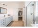 Bright ensuite bathroom with walk-in closet and glass shower at 29339 N 67Th Ave, Peoria, AZ 85383