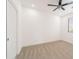 Empty bedroom features neutral carpet, ceiling fan, and a double door closet at 29339 N 67Th Ave, Peoria, AZ 85383