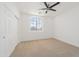 Light, carpeted bedroom with a ceiling fan, window, and closet space at 29339 N 67Th Ave, Peoria, AZ 85383