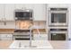 Close up of the kitchen showing the oven, microwave, sink and fixtures at 29339 N 67Th Ave, Peoria, AZ 85383