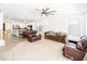 Spacious living room with neutral carpet, ceiling fan, and open access to the kitchen at 29339 N 67Th Ave, Peoria, AZ 85383