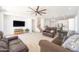 Large living room with carpet, ceiling fan, and an entertainment center at 29339 N 67Th Ave, Peoria, AZ 85383