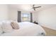 Bright main bedroom features a ceiling fan and large window with desert views and a cozy sitting area at 29339 N 67Th Ave, Peoria, AZ 85383