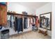 Walk-in closet features built-in shelving, and a cozy stool with decorative mirror at 29339 N 67Th Ave, Peoria, AZ 85383