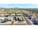 Aerial view of a neighborhood with a mountain range in the background under a blue, cloudy sky at 3256 E Maplewood St, Gilbert, AZ 85297
