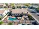 Aerial view of backyard with pool, spa, outdoor kitchen, and covered patio surrounded by privacy fence at 3256 E Maplewood St, Gilbert, AZ 85297