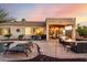 Relaxing backyard features outdoor kitchen, pool, lounge chairs and fire pit for cozy evenings at 3256 E Maplewood St, Gilbert, AZ 85297