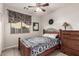 Cozy bedroom with tile flooring, a window with a view, and classic wooden furniture for a comfortable retreat at 3256 E Maplewood St, Gilbert, AZ 85297