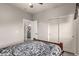 Neutral bedroom with a view into a bathroom and a large closet with white doors at 3256 E Maplewood St, Gilbert, AZ 85297