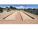 Outdoor recreational area featuring bocce ball courts and manicured landscapes that provide options for leisure and community engagement at 3256 E Maplewood St, Gilbert, AZ 85297
