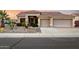 Charming home featuring a desert landscape, two-car garage, and tile roof against a beautiful sunset sky at 3256 E Maplewood St, Gilbert, AZ 85297