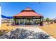 Community gazebo with picnic tables in a park-like setting with blue skies at 3256 E Maplewood St, Gilbert, AZ 85297