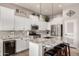 Bright kitchen with white cabinets, granite countertops, stainless steel appliances, and a center island with bar stool seating at 3256 E Maplewood St, Gilbert, AZ 85297