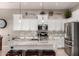 Bright kitchen featuring white cabinets, stainless steel appliances, granite countertops and island with seating at 3256 E Maplewood St, Gilbert, AZ 85297