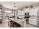 Open kitchen with a granite island, stainless appliances, and an eat-in kitchen area, perfect for modern living at 3256 E Maplewood St, Gilbert, AZ 85297
