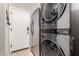 Laundry room with stacked washer and dryer units, and exterior door at 3256 E Maplewood St, Gilbert, AZ 85297