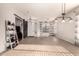 Bright open-concept living room showcasing tile floors and a decorative sliding barn door at 3256 E Maplewood St, Gilbert, AZ 85297