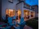Inviting backyard features pavers, Adirondack chairs, fire pit, covered patio, and lush lawn at 3261 S Sunland Dr, Chandler, AZ 85248