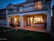 Well-lit backyard features covered patio, BBQ, lounge seating, and a second story balcony at 3261 S Sunland Dr, Chandler, AZ 85248
