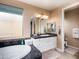 Inviting bathroom with a soaking tub, vanity, and a window creating a relaxing atmosphere at 3261 S Sunland Dr, Chandler, AZ 85248