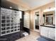 Bright bathroom featuring a walk-in shower with glass block, dual sink vanity, and neutral color scheme at 3261 S Sunland Dr, Chandler, AZ 85248