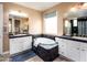 Bright bathroom featuring a soaking tub with tiled surround, dual sink vanity, and a window for natural light at 3261 S Sunland Dr, Chandler, AZ 85248