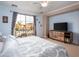 Comfortable bedroom featuring a wooden dresser and balcony access, combining style and functionality at 3261 S Sunland Dr, Chandler, AZ 85248