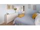 Light bedroom features a white dresser with modern art and a bed with striped bedding at 3261 S Sunland Dr, Chandler, AZ 85248
